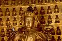 Bronze Buddha figure inside the bronze pagoda.